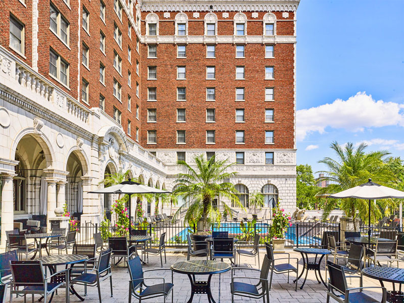 Royal Sonesta Chase Park Plaza outdoor pool area with palm trees and seating